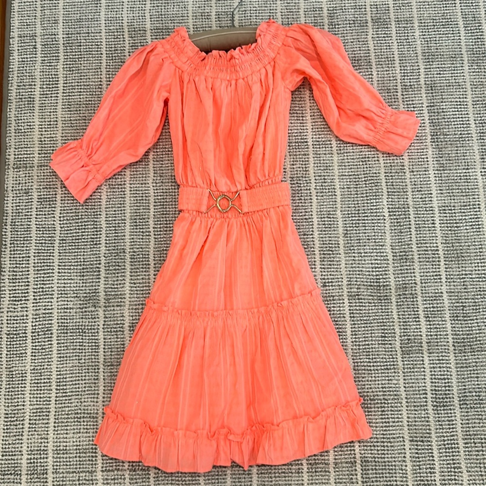 This is a salmon Lily dress with silver stitching.